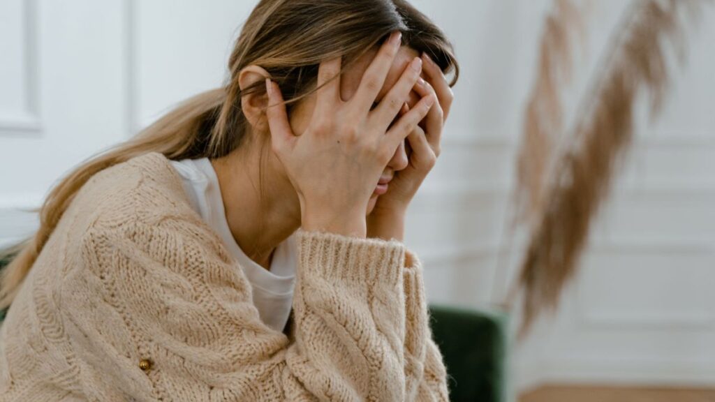 stressed women with hands on face