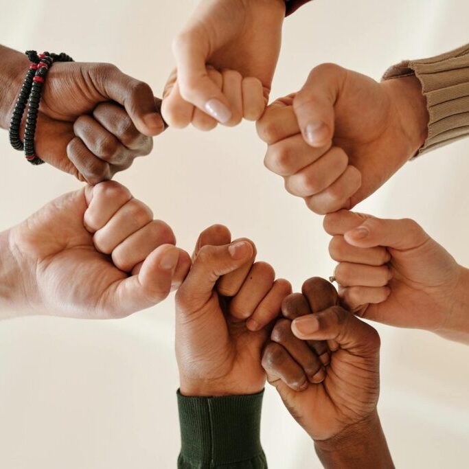 teens putting hands in