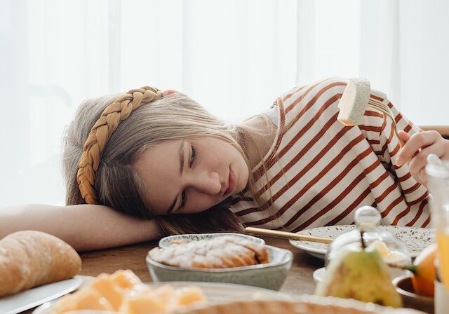 Woman with eating disorder looking at food